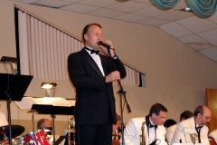 Kent at the Microphone Getting the Crowd to Contribute!